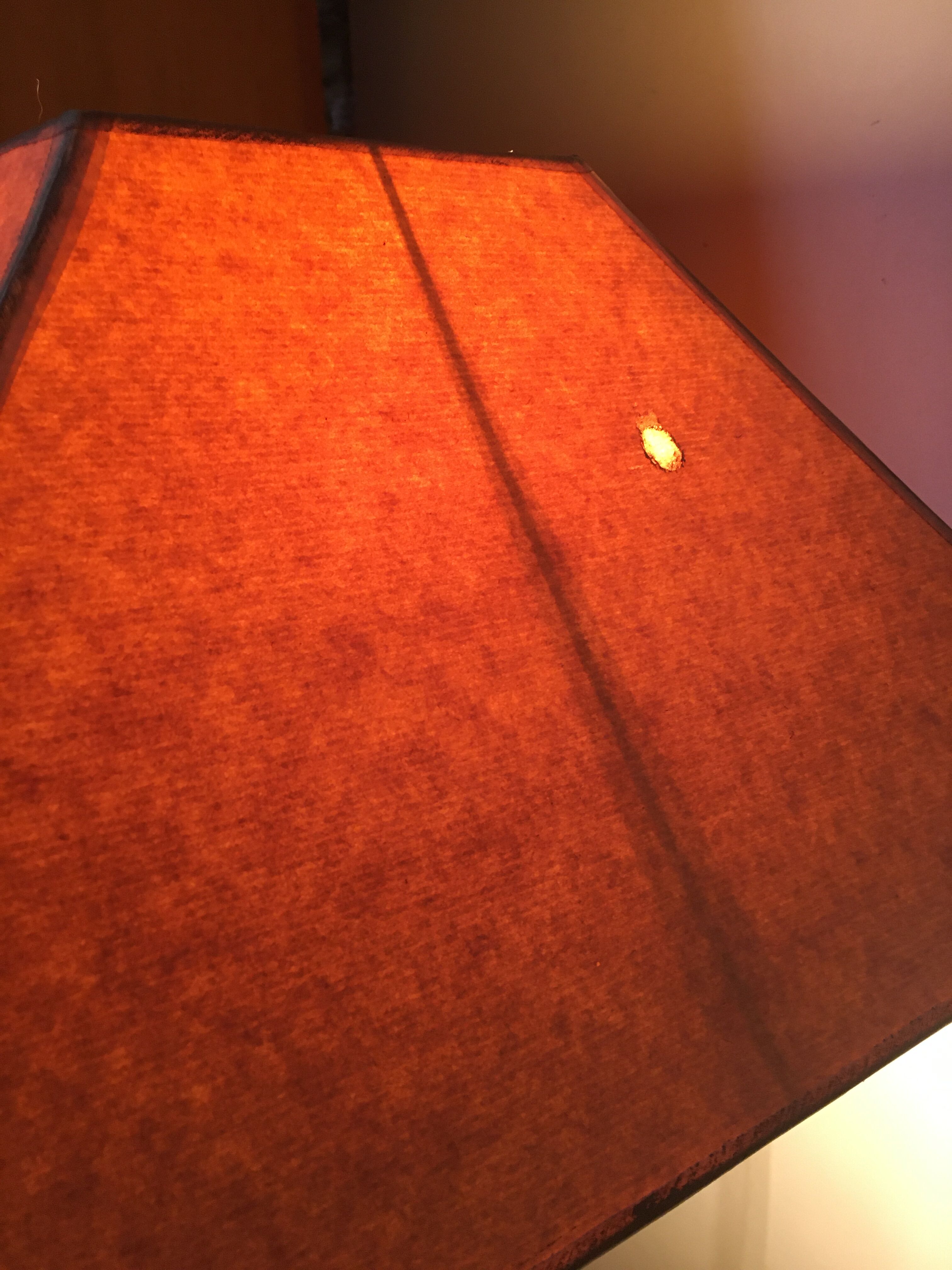 Mahogany lamp with a sculpted base.