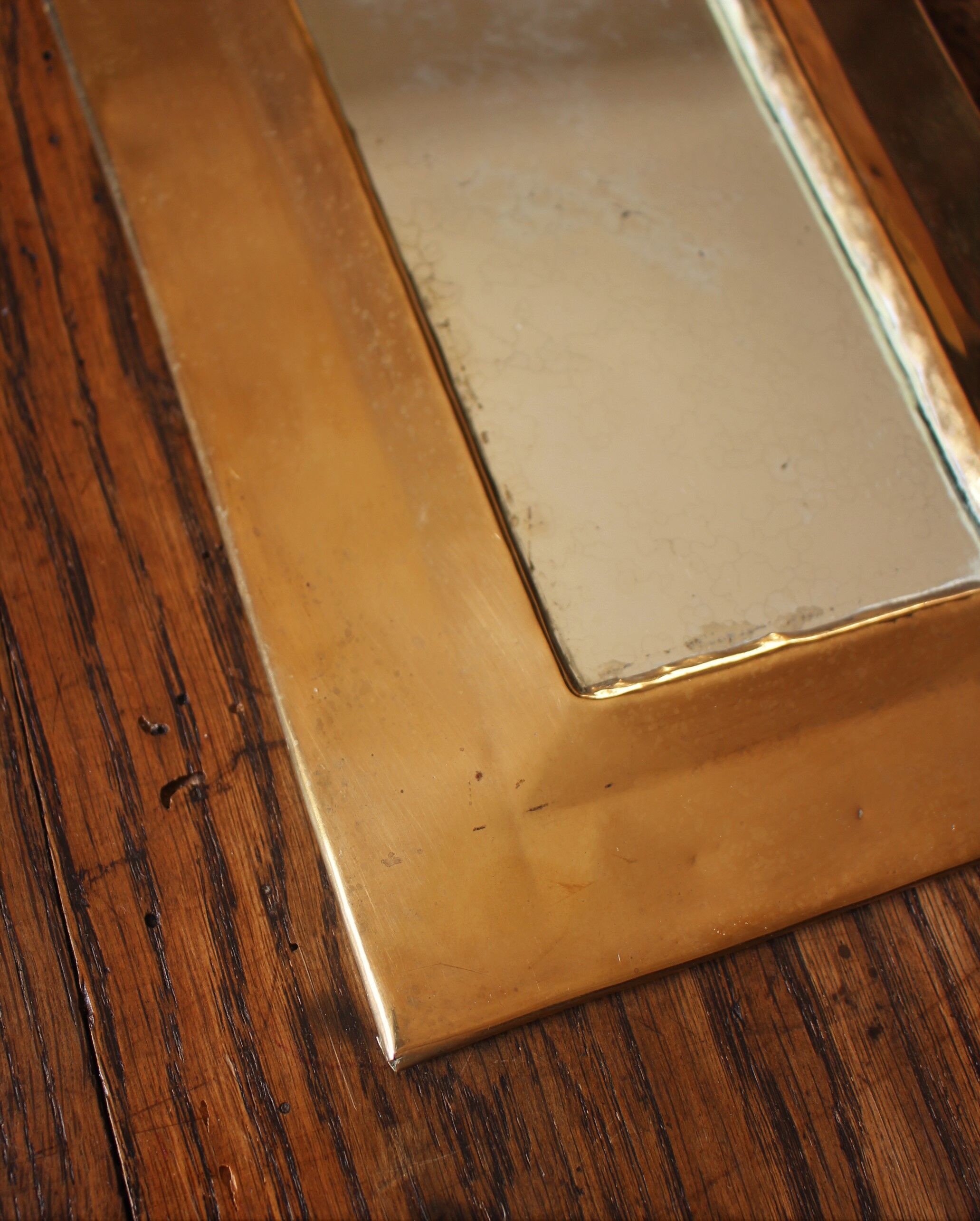 Rounded brass mirror