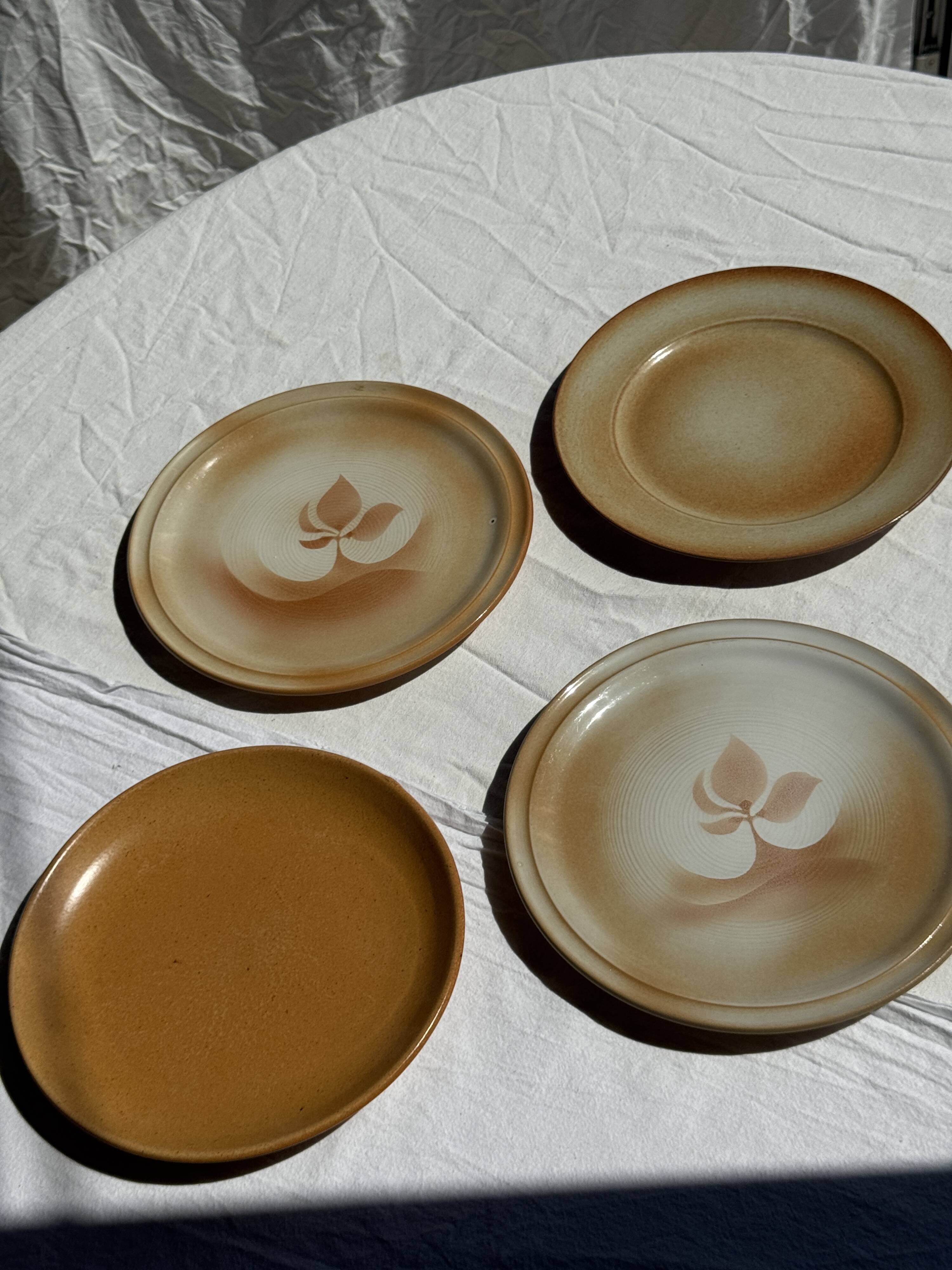 Set of 4 vintage stoneware plates, including 2 with floral motifs