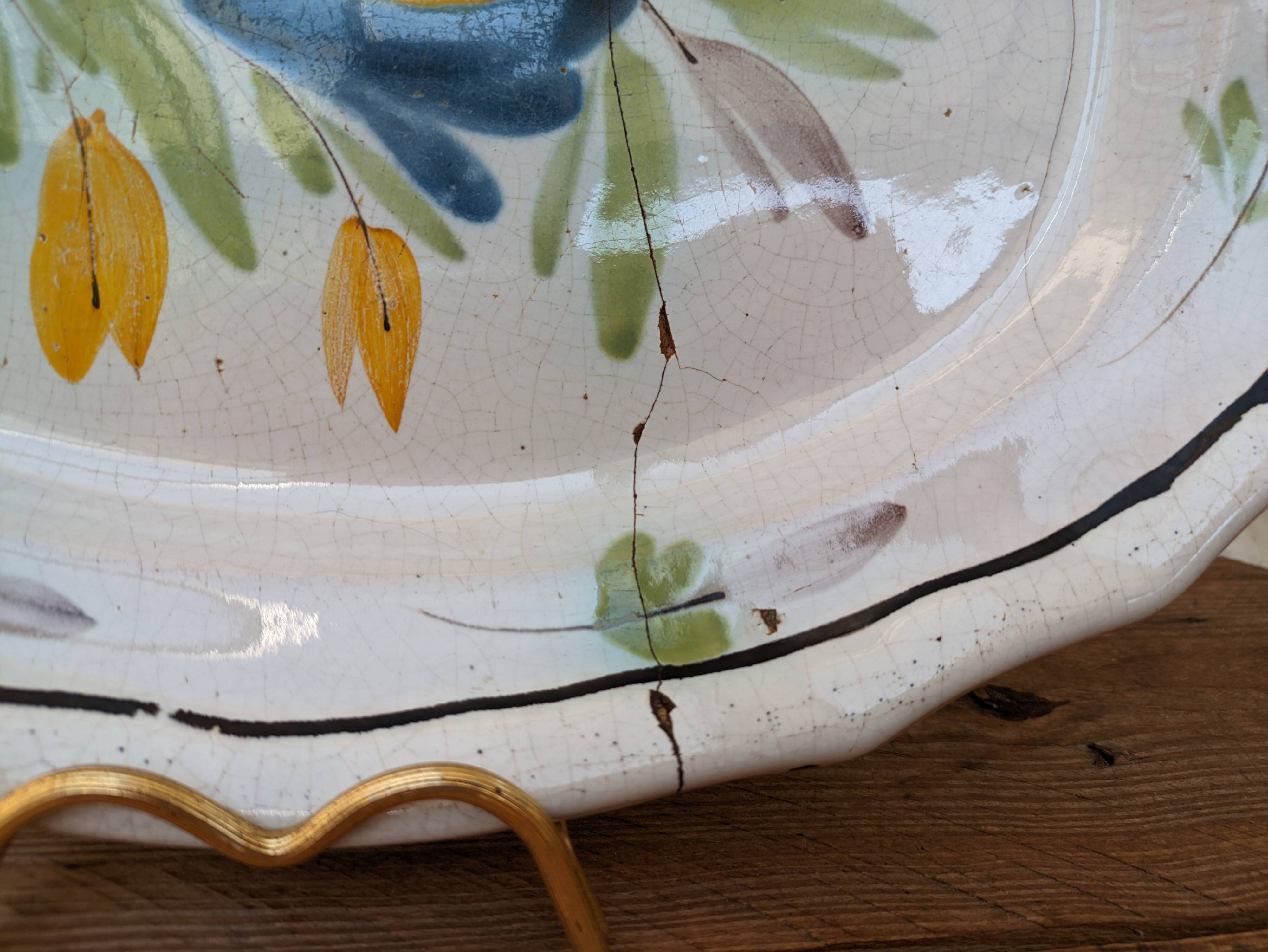Old oval dish with floral motif called black bottom with staples