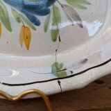 Old oval dish with floral motif called black bottom with staples
