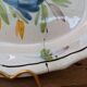 Old oval dish with floral motif called black bottom with staples