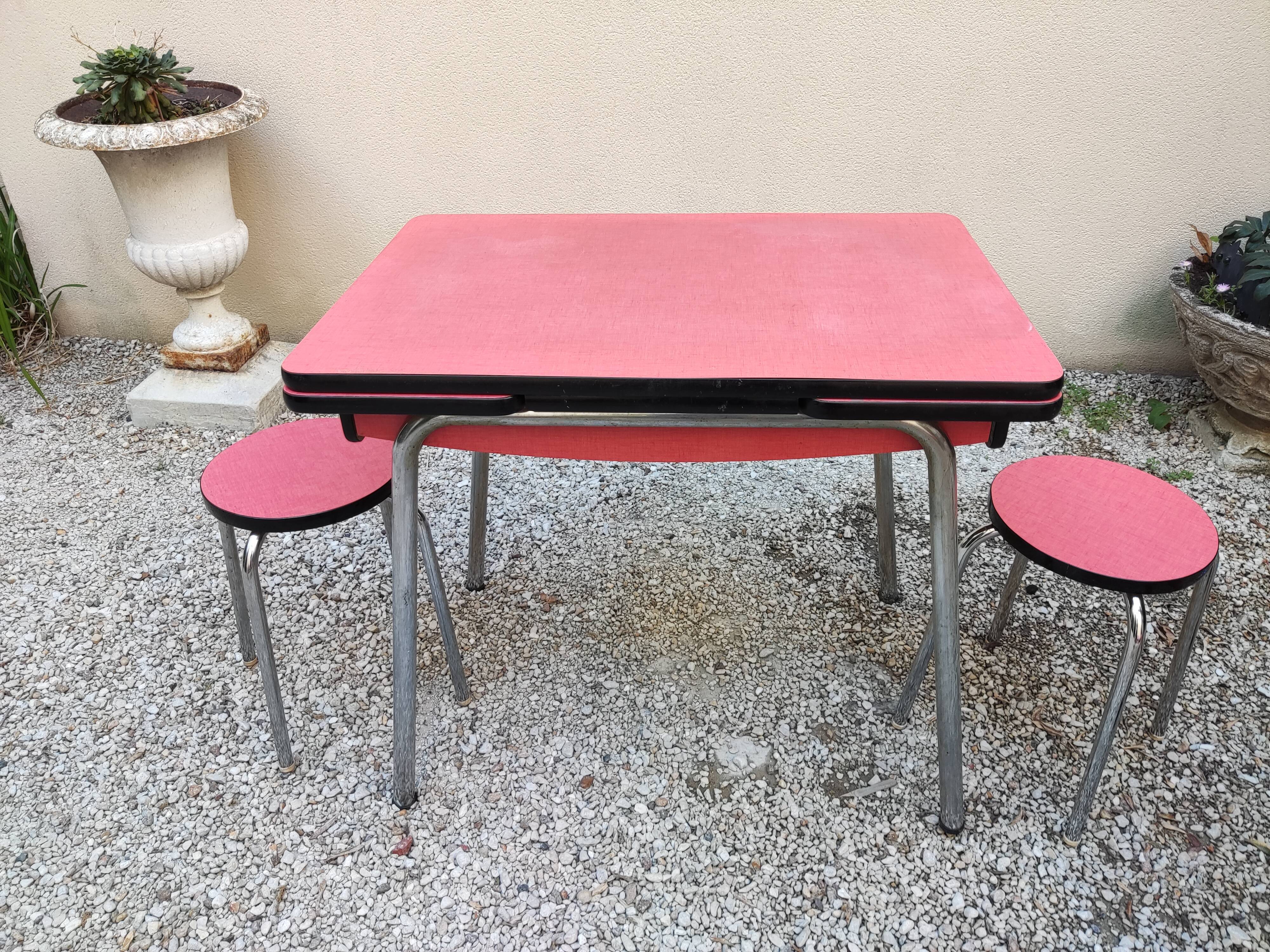 Table with two stools in red formica