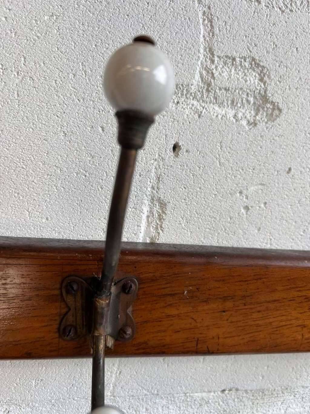 Vintage industrial wooden coat rack with porcelain hooks