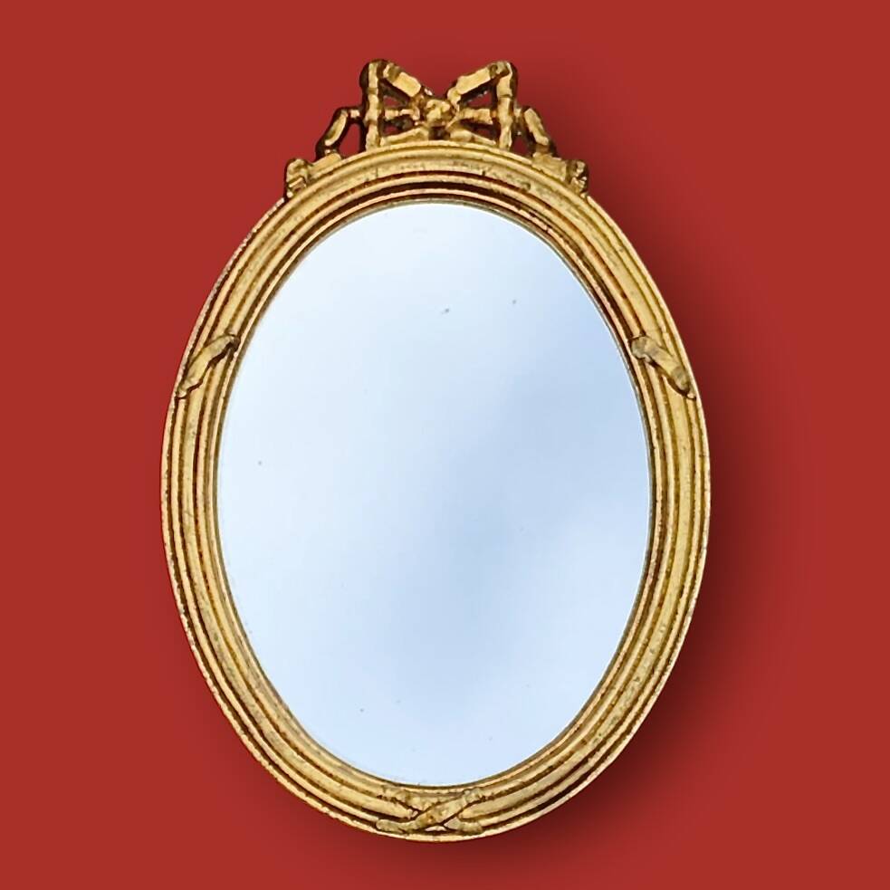 Antique oval mirror in gilded resin with Louis XVI style knot decoration