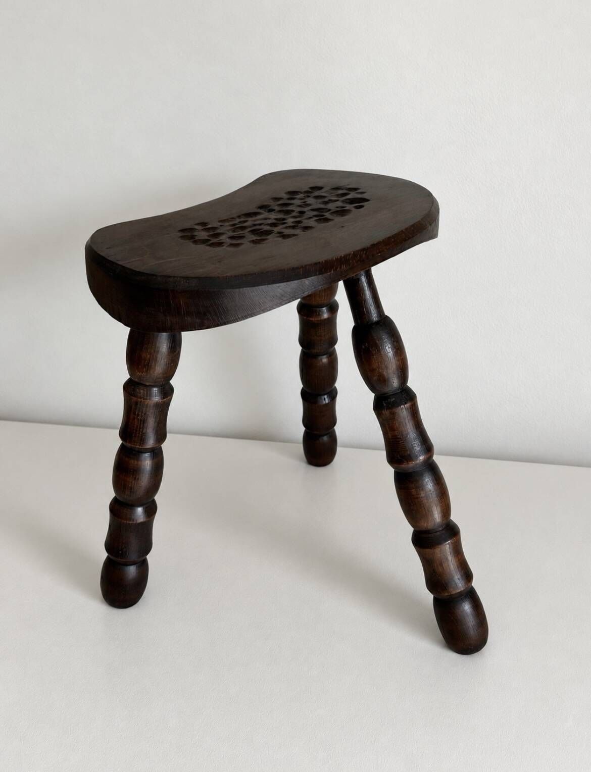 Restored dark wood tripod stool, bobbin leg, elegant furniture.