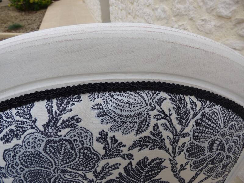 Voltaire style armchair covered in floral fabric in quality aged wood