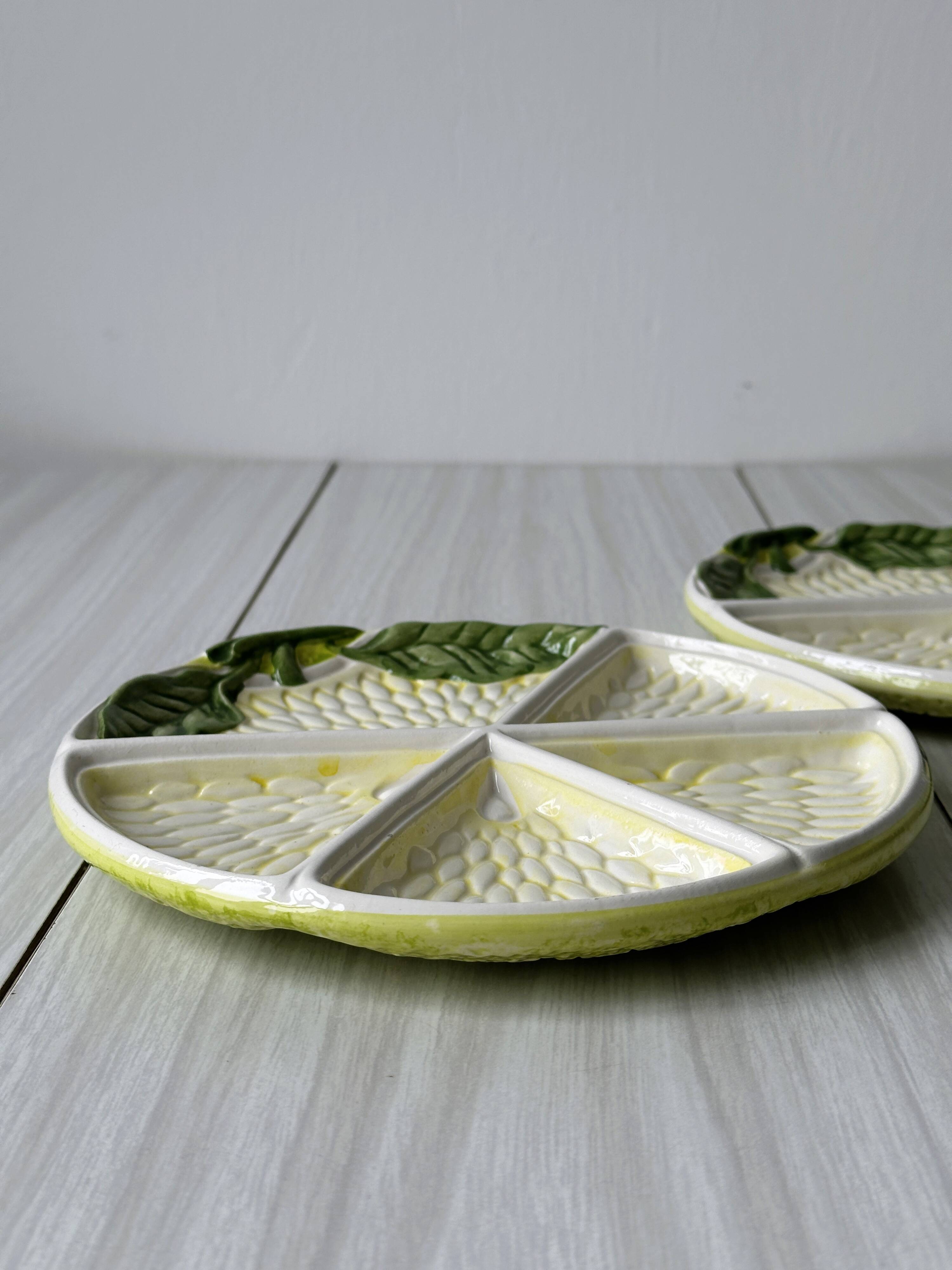 2 ceramic plates depicting a lemon