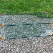 1970s designer coffee table in glass, plexiglass, and gold metal.