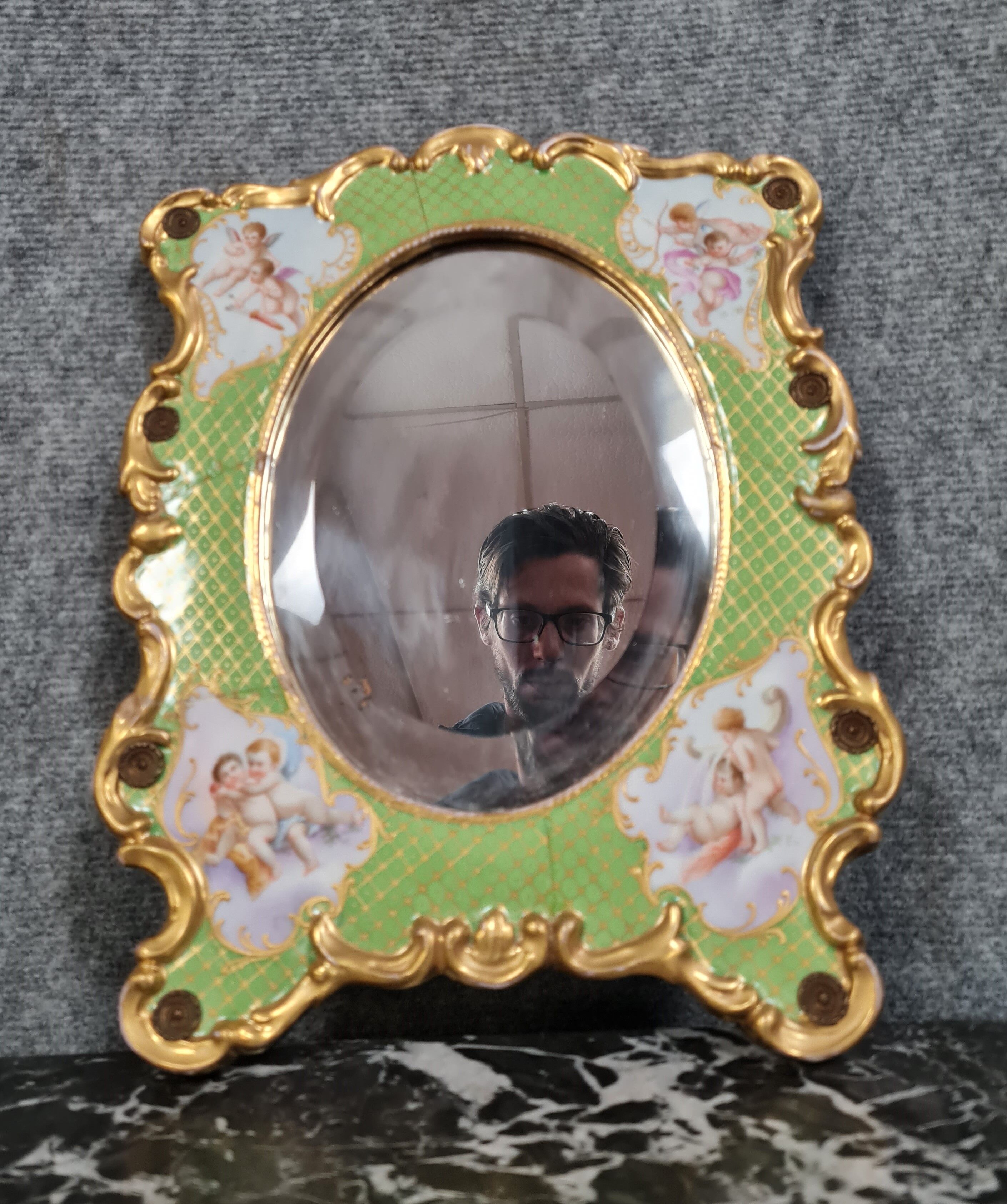 Porcelain mirror with cherub decorations circa 1900