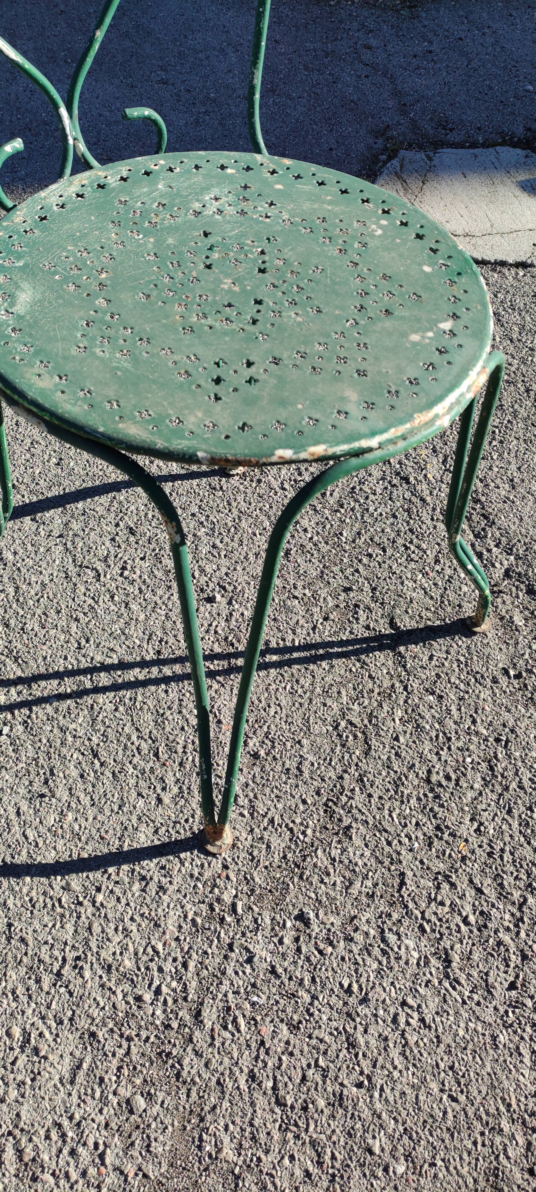 Garden table, two armchairs and a metal chair