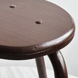 Dark brown metal stool, minimalist three-legged design