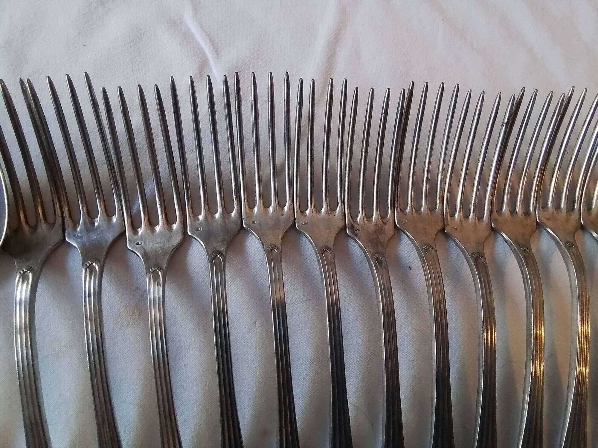 12 Art Deco forks and 12 Bouillet Bourdelle soup spoons.