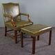 Elegant armchair and footrest in English green leather
