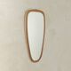 Wonderful 1950s mirror on a teak wood panel with brass frame. Made in Germany