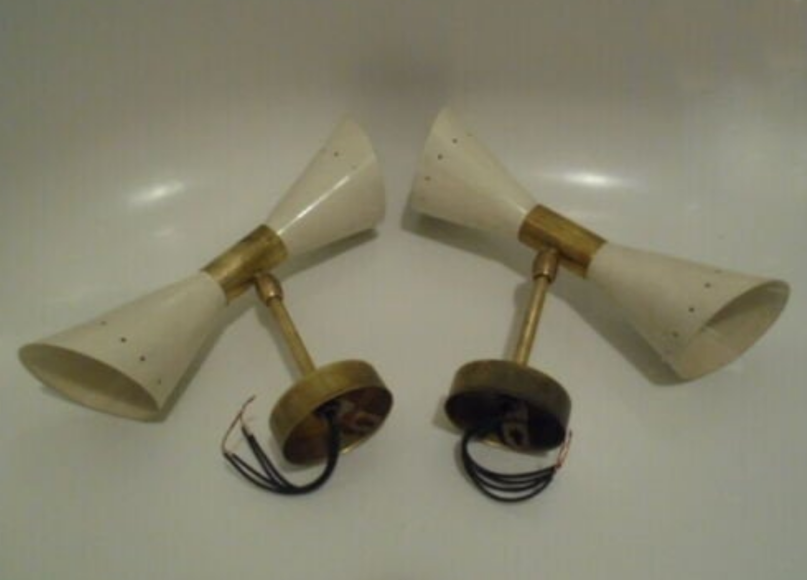 Pair of wall sconces remembering the Italian creations from the 50s and 60's
