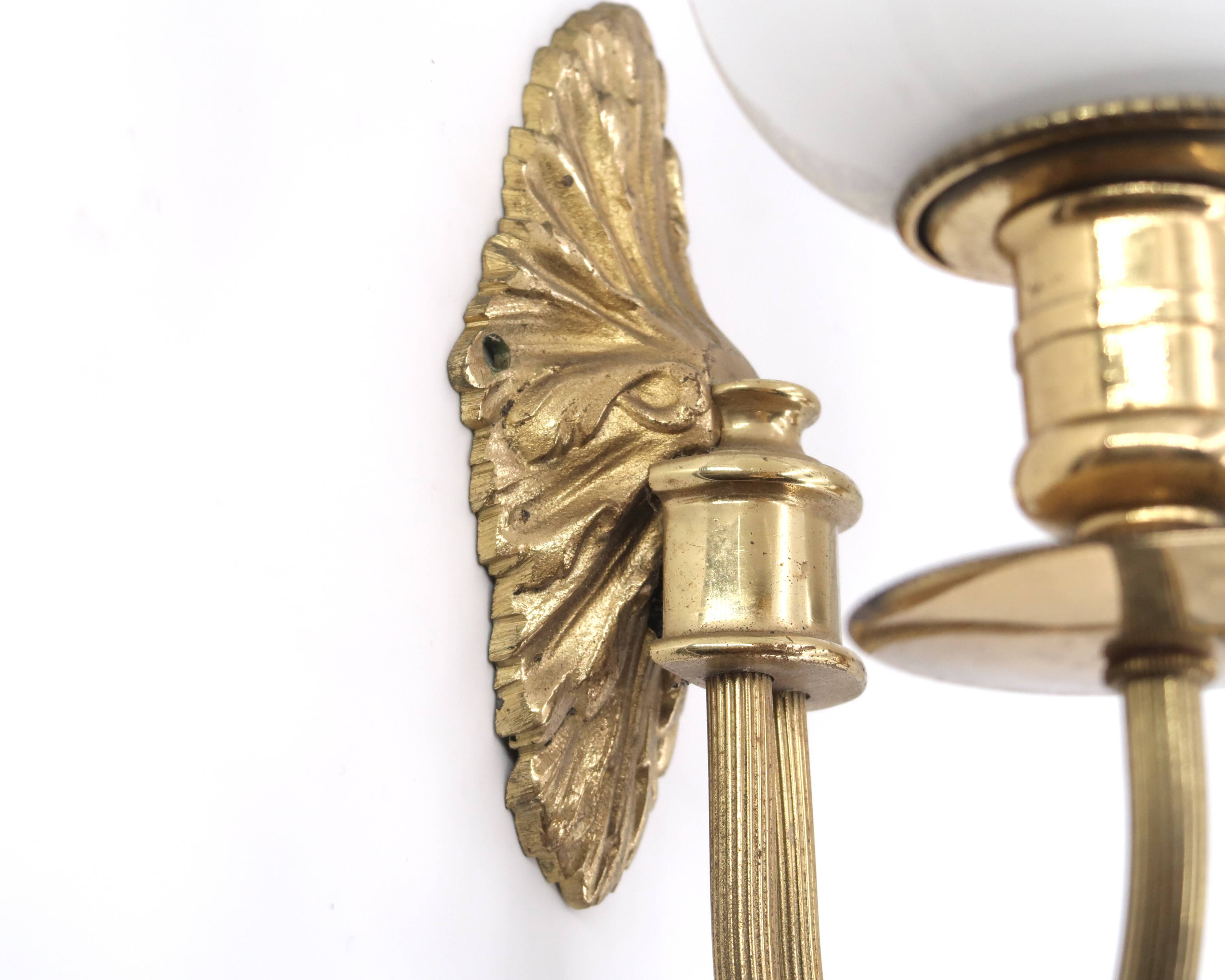 Three wall lights in brass and opaque glass, 1950s