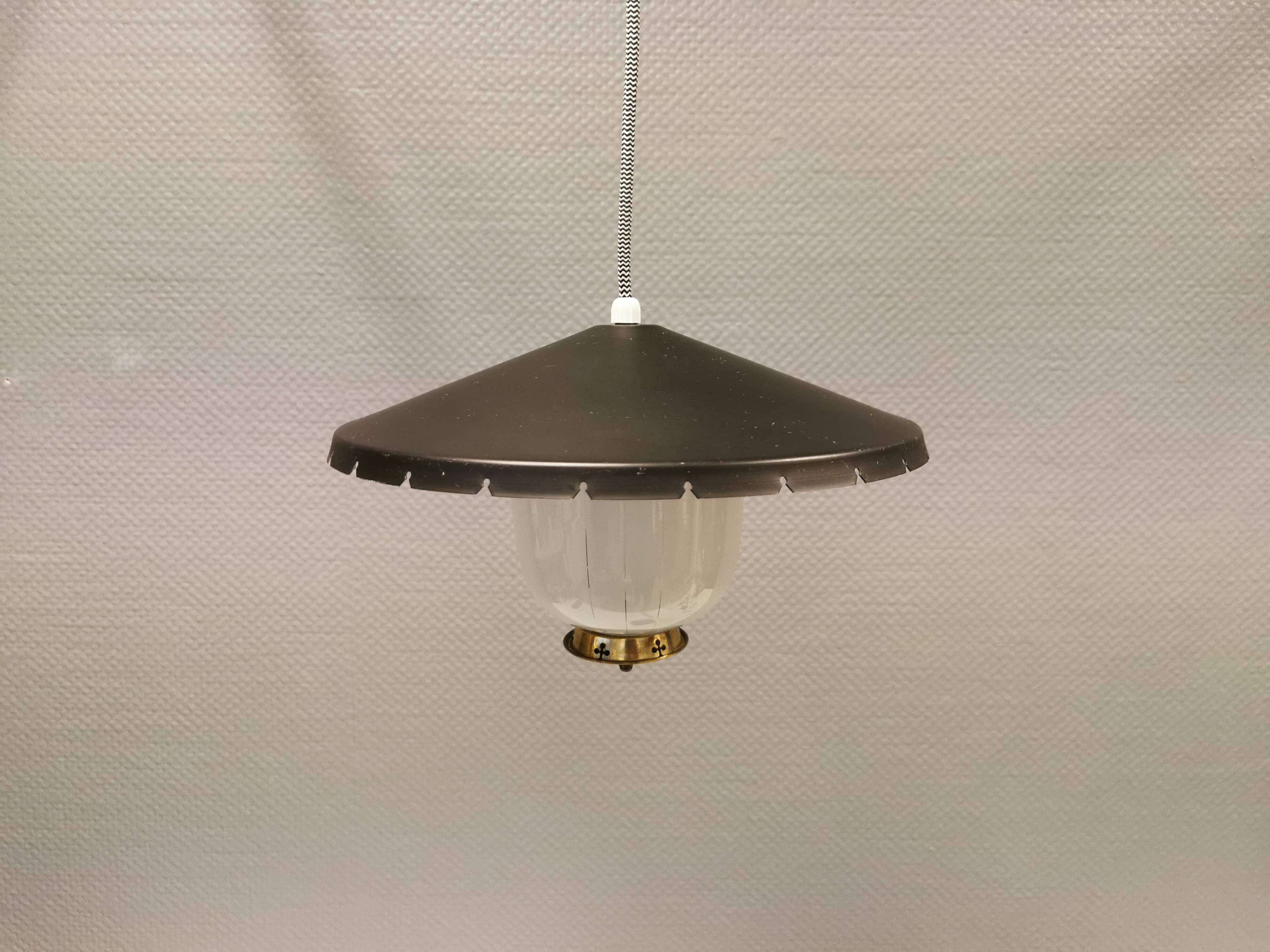 Hanging lamp in glass with black lacquered metal shade and brass base.