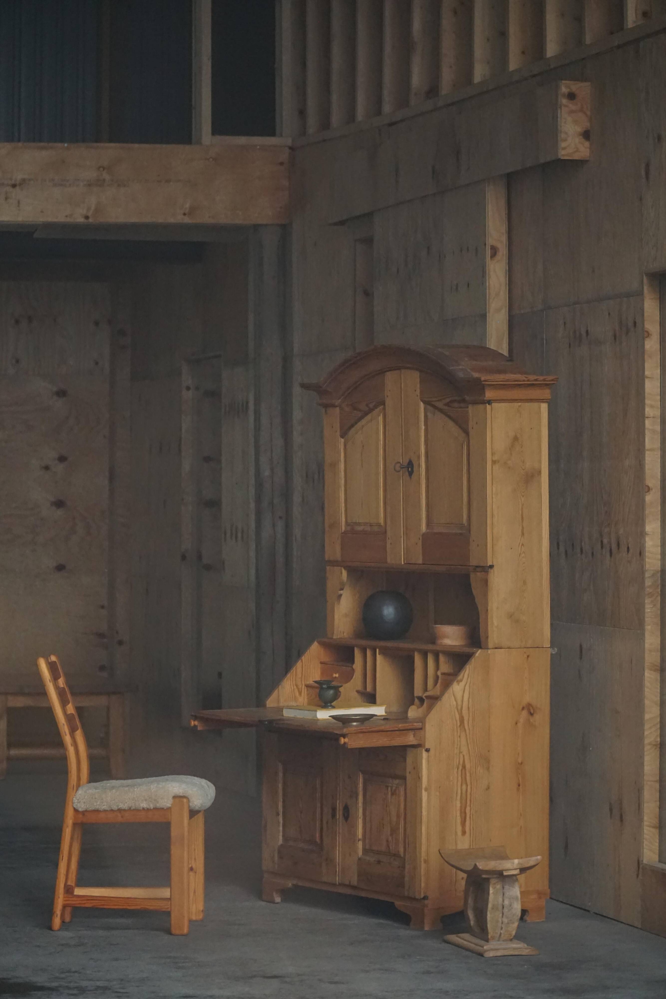 Old Danish secretary in pine with drop-down front and upper cabinet, mid-19th century.