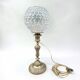 Antique brass foot lamp with glass globe and diamond point.