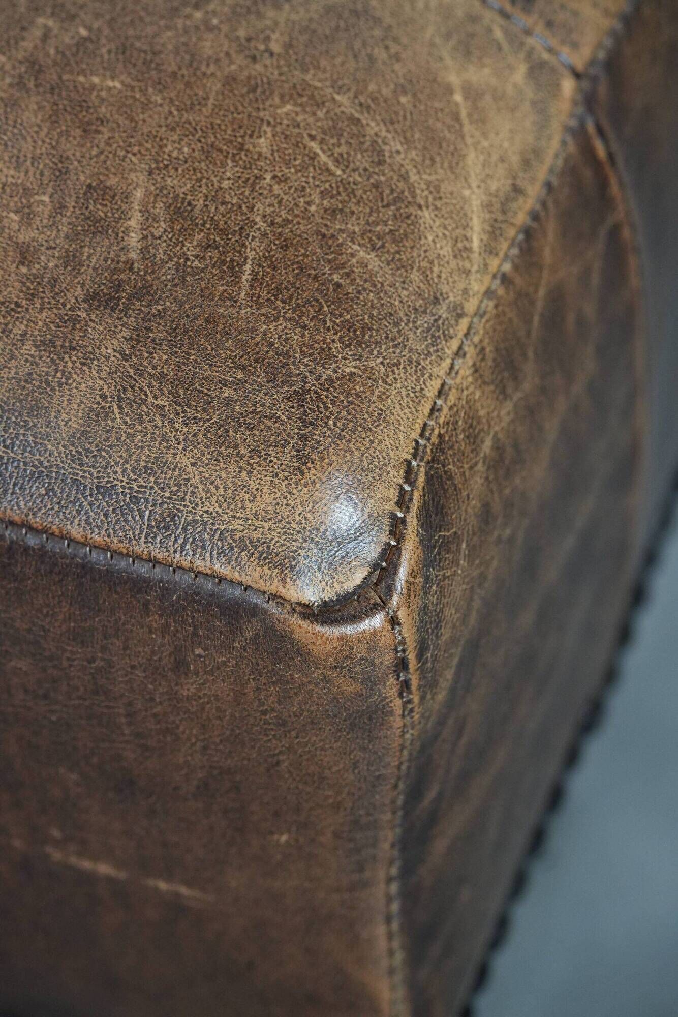 Beautiful sheepskin ottoman on high legs and beautiful warm colours