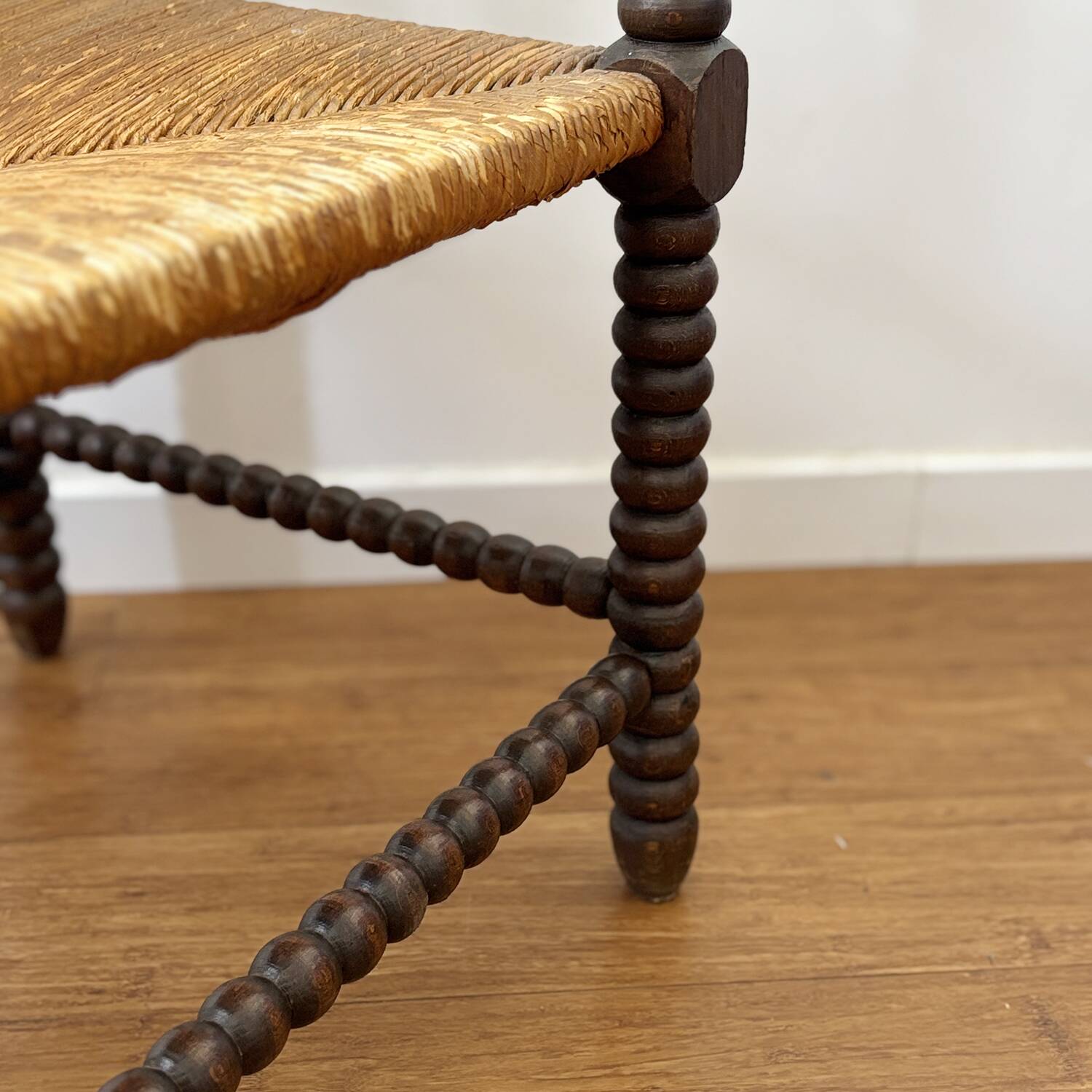 Turned wood corner chair with straw seat