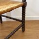 Turned wood corner chair with straw seat
