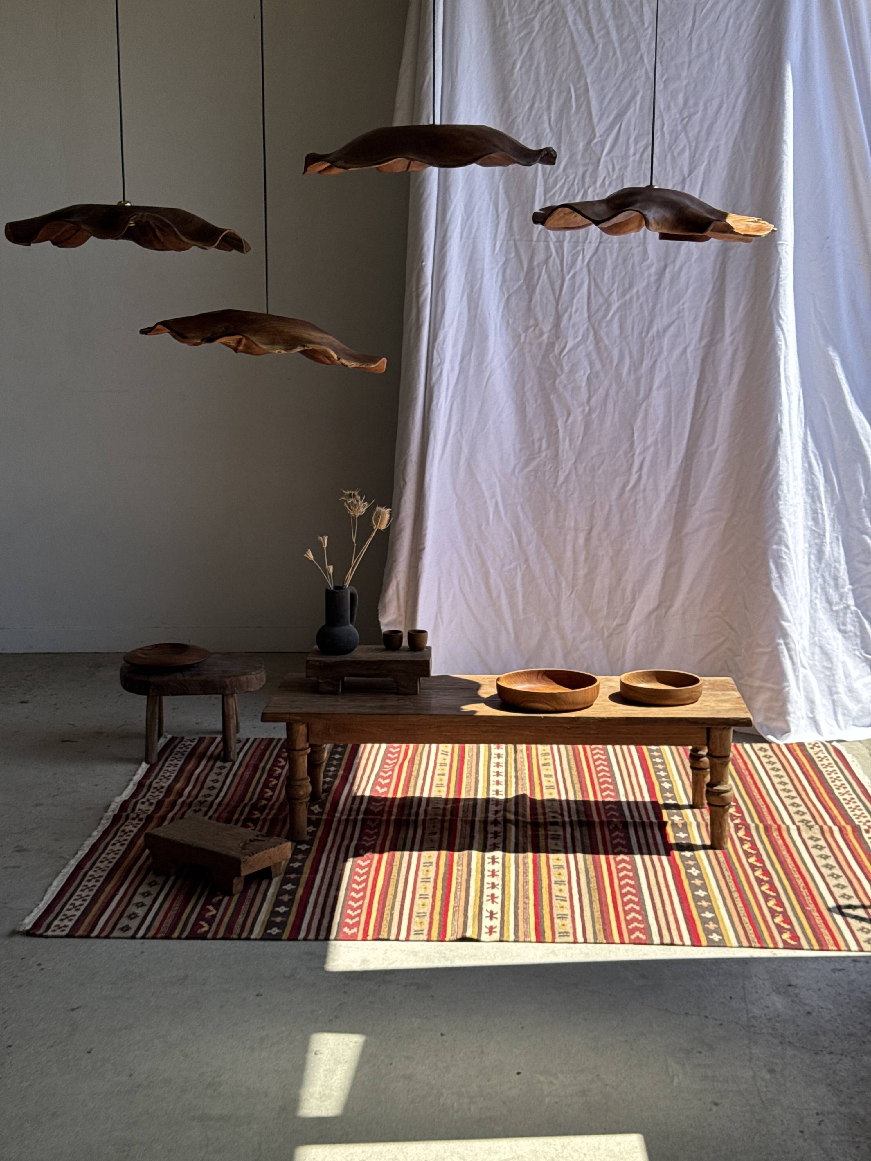 Large Indian rug with red, yellow, and white stripes and geometric fringes.