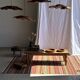 Large Indian rug with red, yellow, and white stripes and geometric fringes.
