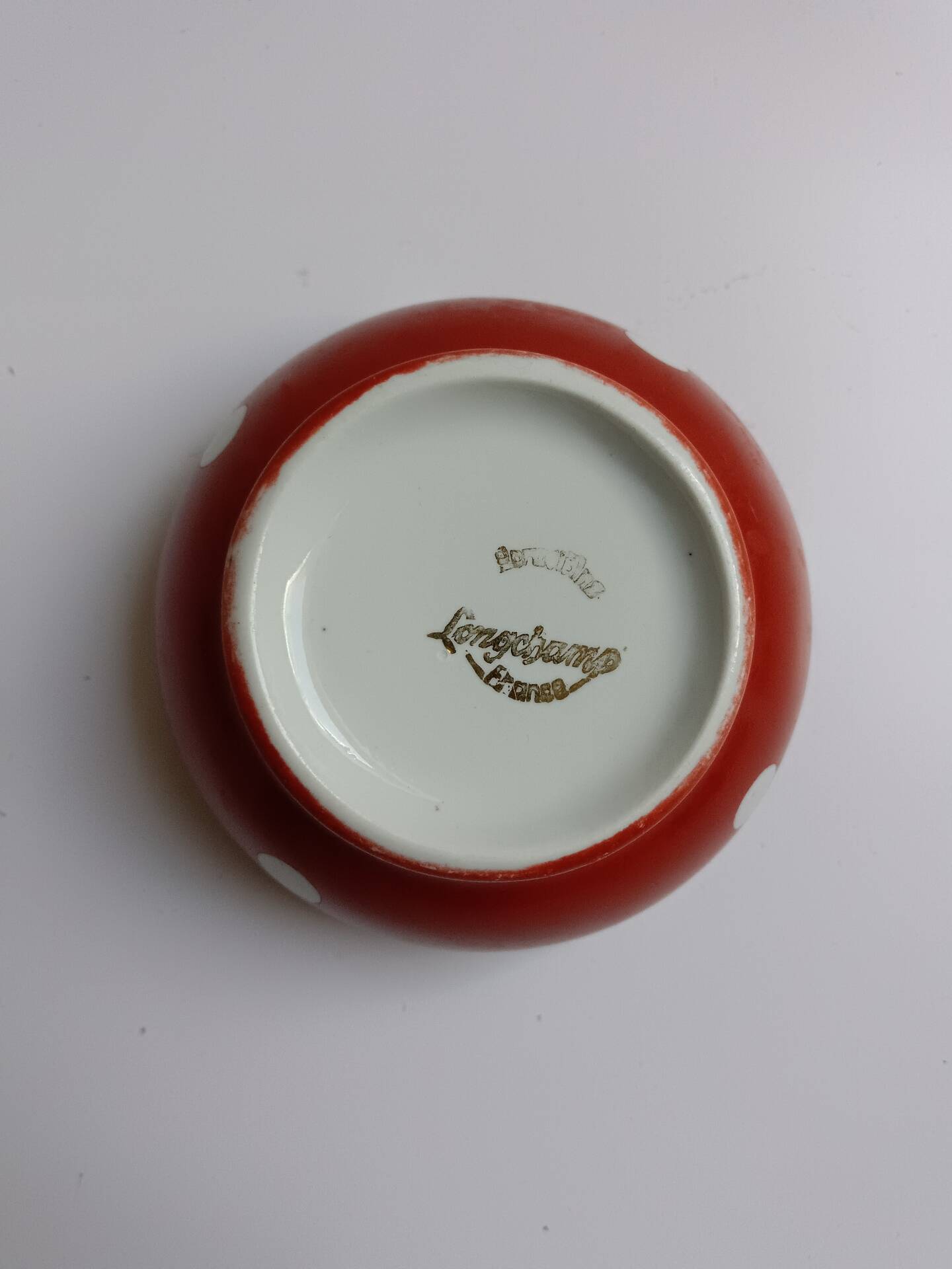 Red bowl with white polka dots in Longchamp ceramic