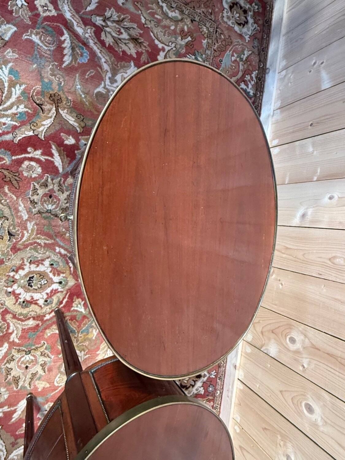 Pair of oval Louis XVI bedside tables in mahogany.