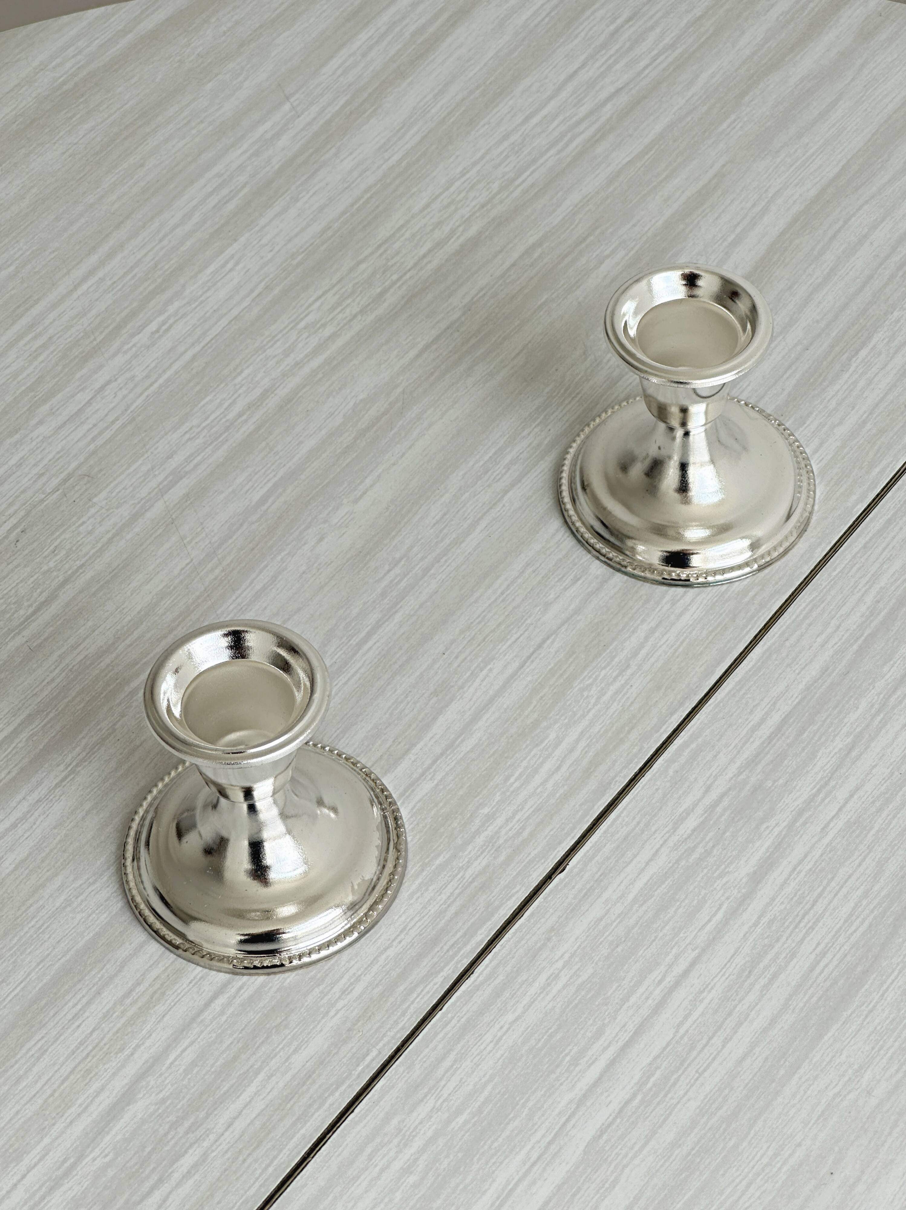 Pair of lightweight silver metal candlesticks