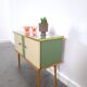 Vintage green DDR cabinet, model Libelle with glass top, slanted legs.