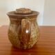 Large antique brown glazed stoneware jug with cork stopper.