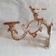Wall lamp in antique cast iron with bird and scroll decorations.