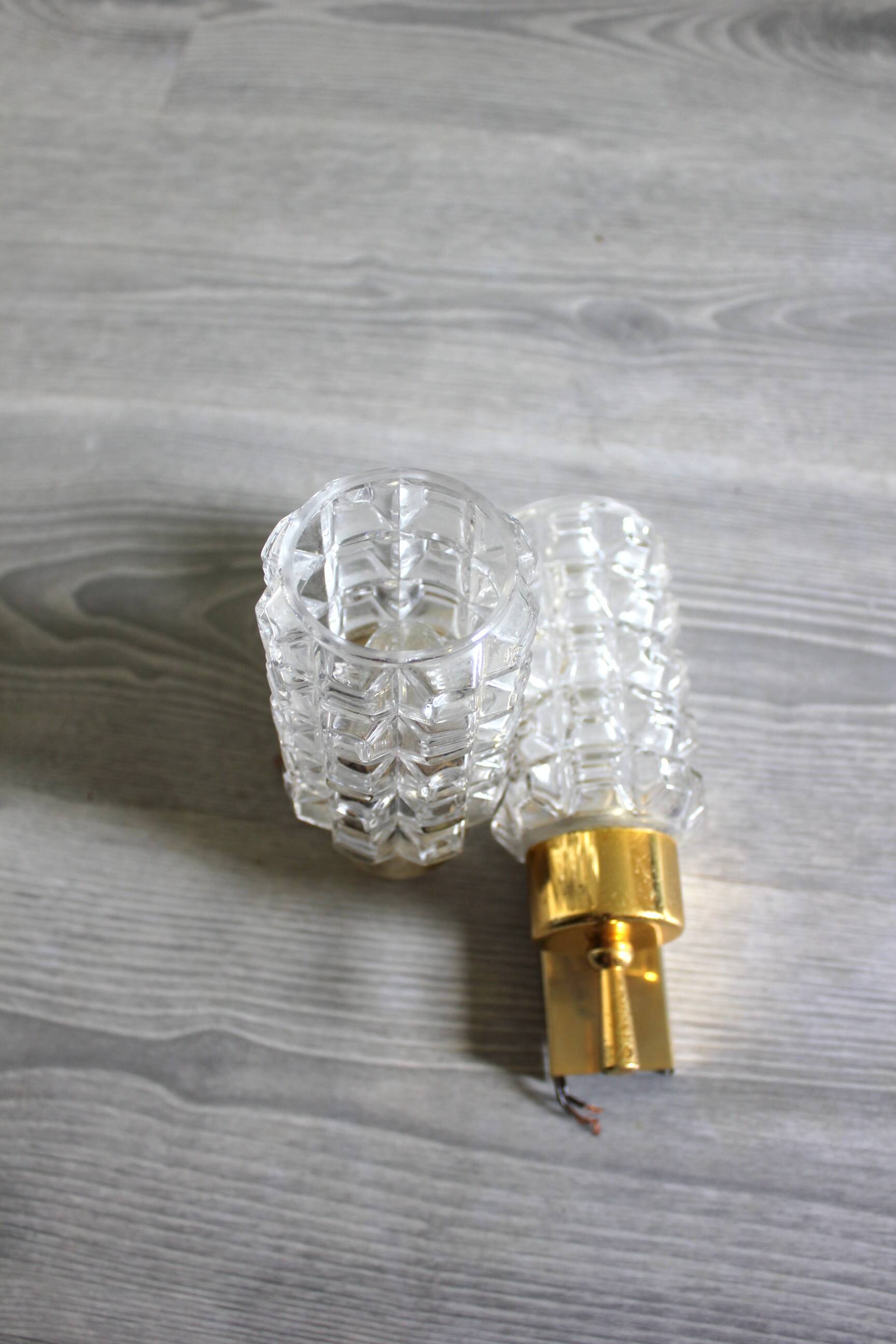 Pair of vintage wall sconces in gilded brass with moulded glass.