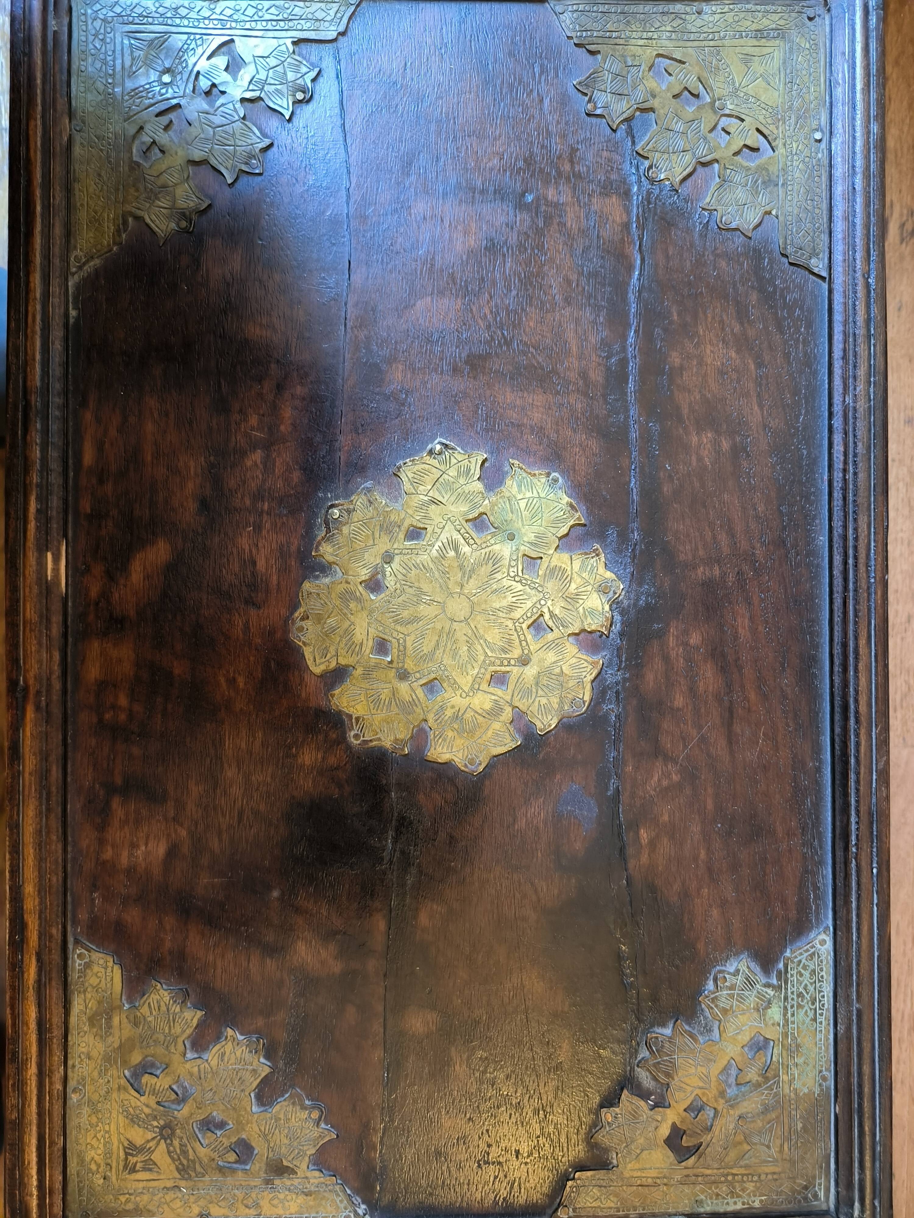 Old Indian wooden wedding chest decorated with chiseled brass plaque. India late 19th/early 20th
