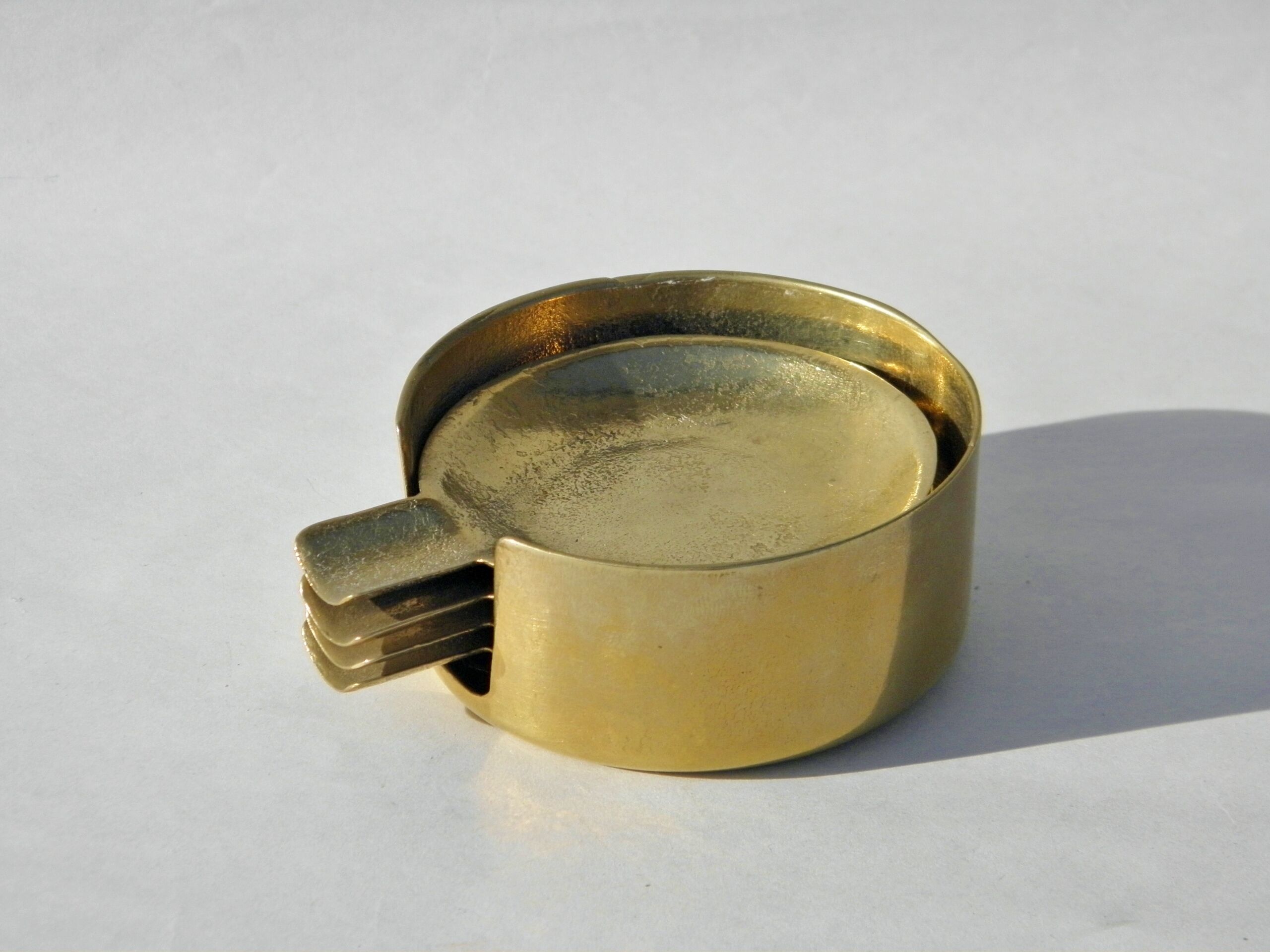 4 brass ashtrays in their 1970 case