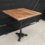 Bistro table with cast iron base and teak top