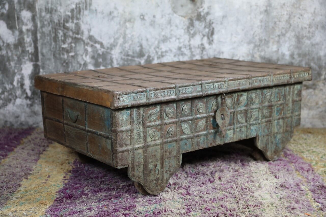 Low chest with metal closure and top opening.