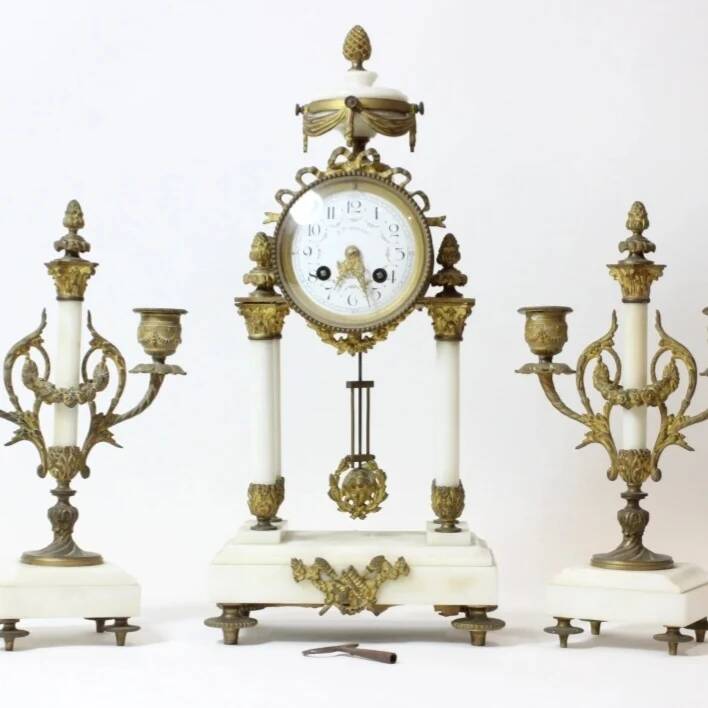 Clock and pair of Louis XVI style candelabras.