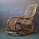 Vintage rocking chair in rattan from the 60s-70s, high openwork backrest.