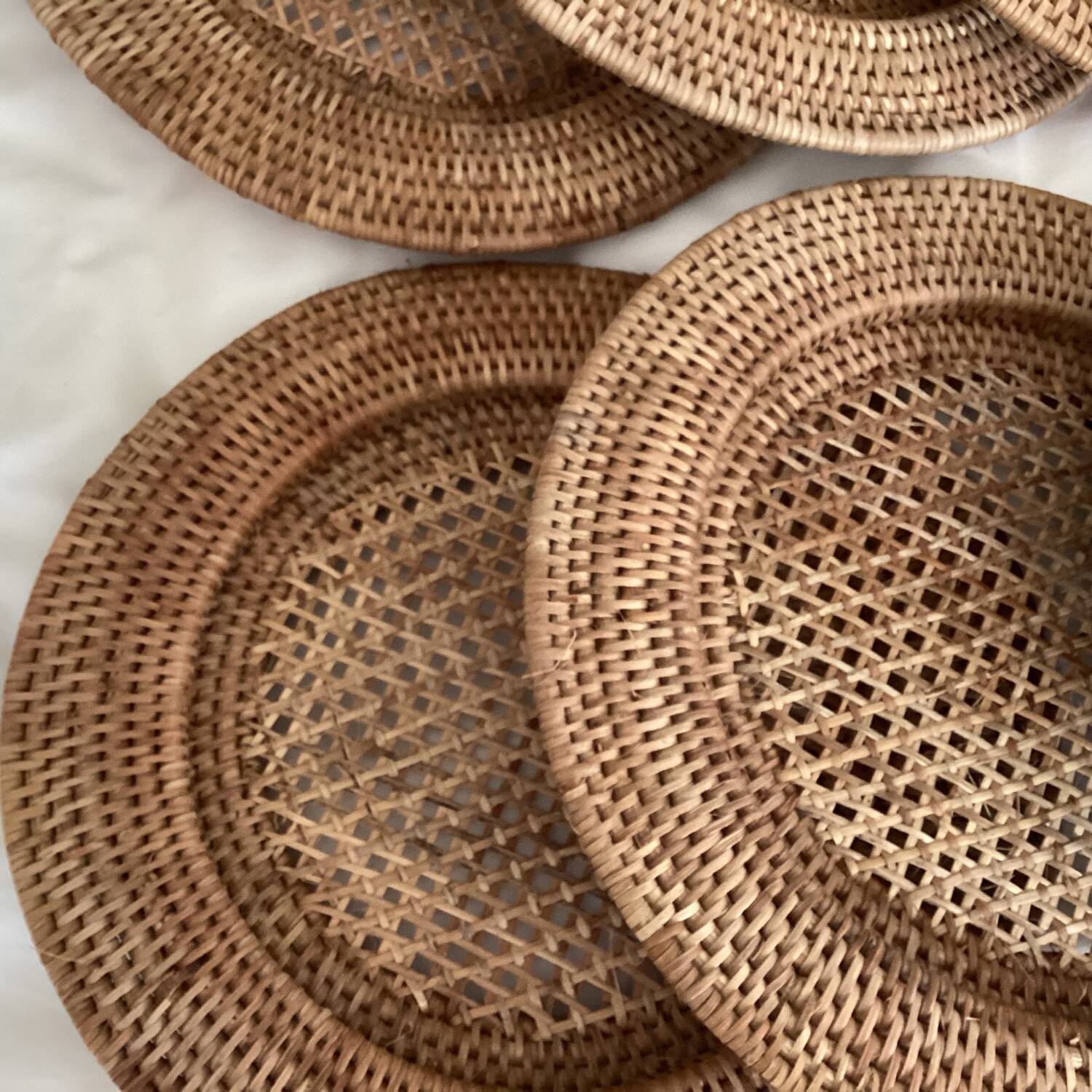 Set of round woven rattan and canework coasters