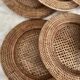 Set of round woven rattan and canework coasters