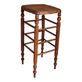 Antique stool with cane and turned wood