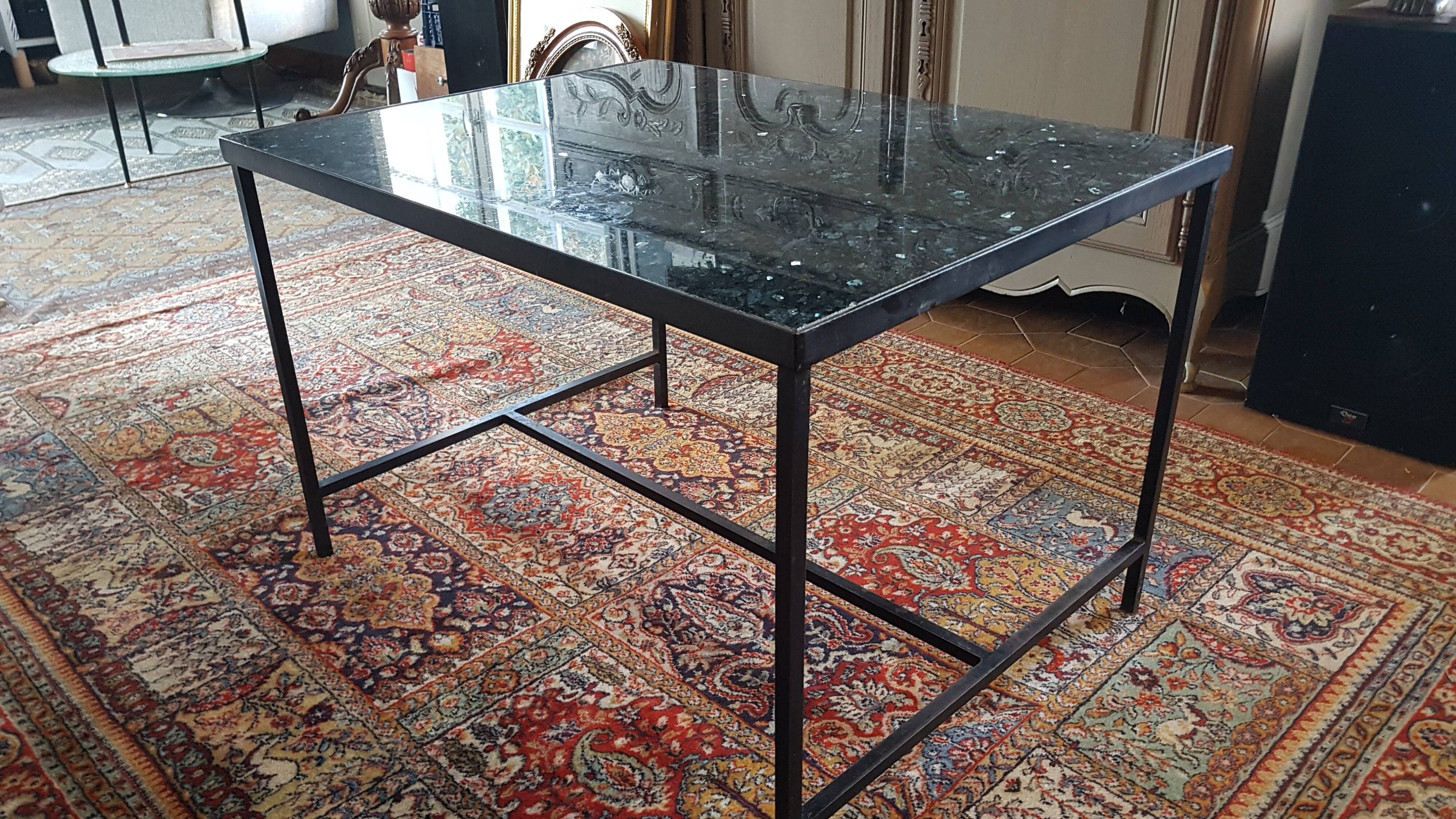 Coffee table with top in silver granite and welded steel base.