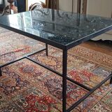 Coffee table with top in silver granite and welded steel base.