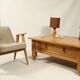 Rustic vintage style coffee table in light wood, mid-century modern design.