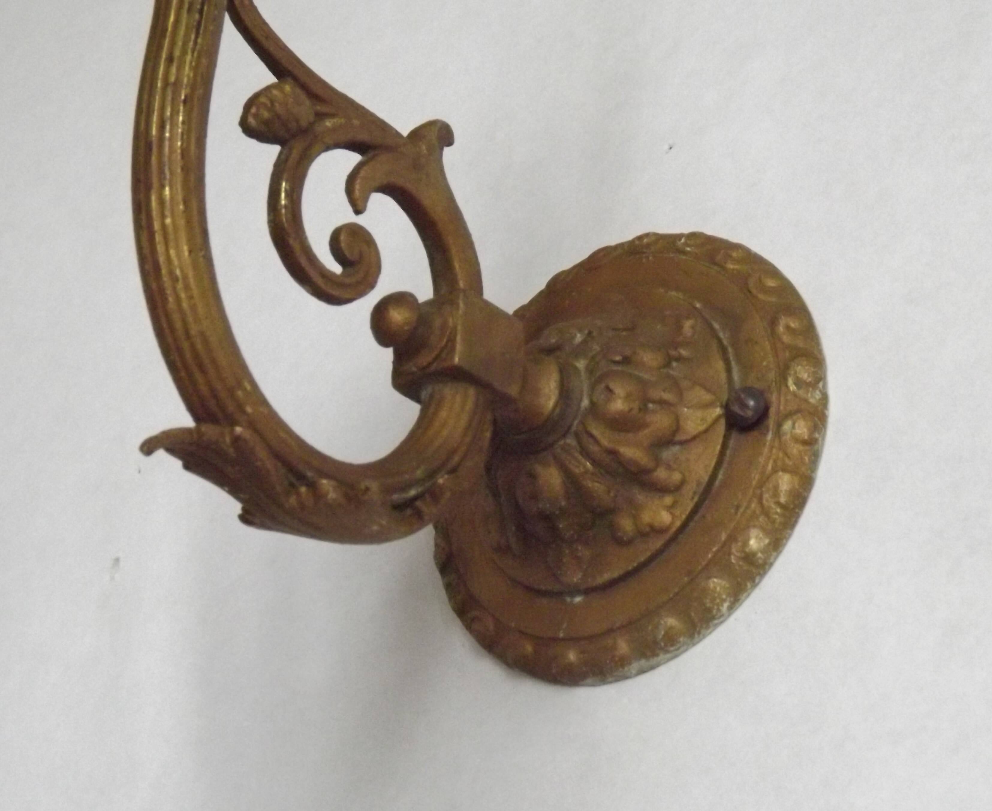French Art Nouveau wall sconce in bronze with a white and pink glass shade.