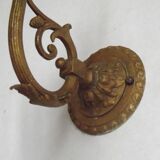 French Art Nouveau wall sconce in bronze with a white and pink glass shade.